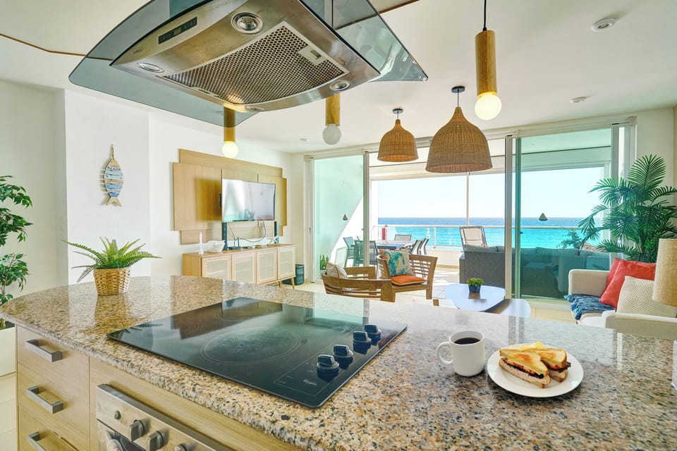 Beachfront Living Room – Relax with A/C, Smart TV, and ocean views — your cozy corner by the beach.