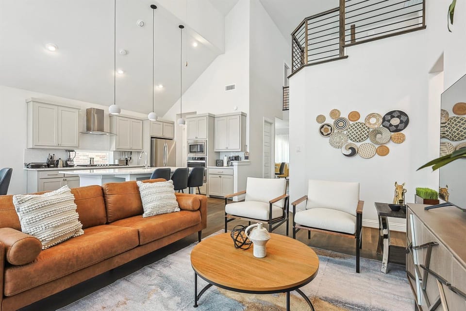 Offering the best of elegance, luxury, and cozy comfort, this living room has it all – high ceilings, a fireplace, tasteful furniture, and designer décor!