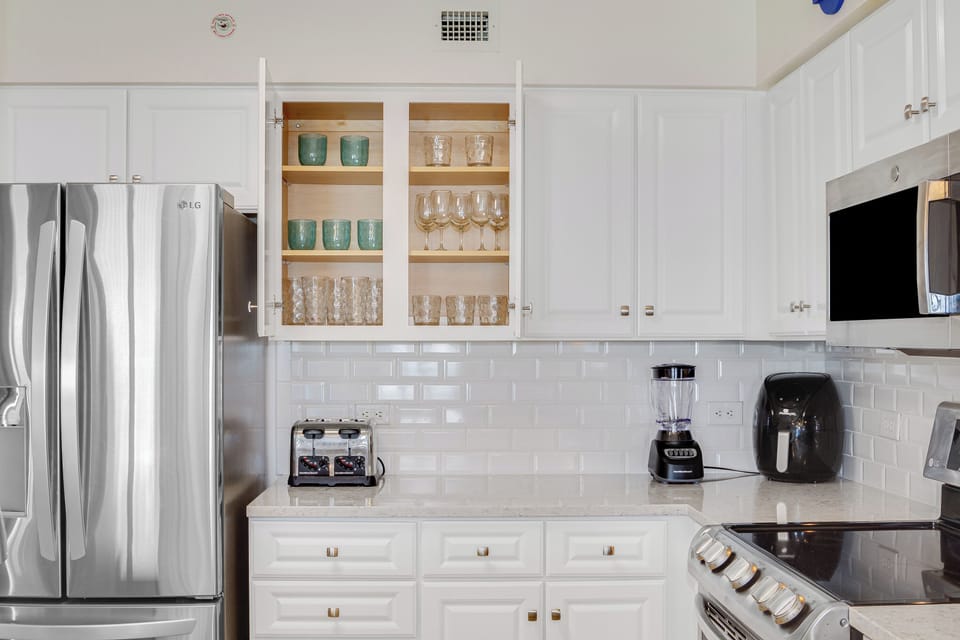 Your bright, modern kitchen features stainless steel appliances and gleaming white cabinets stocked with everything you need.
