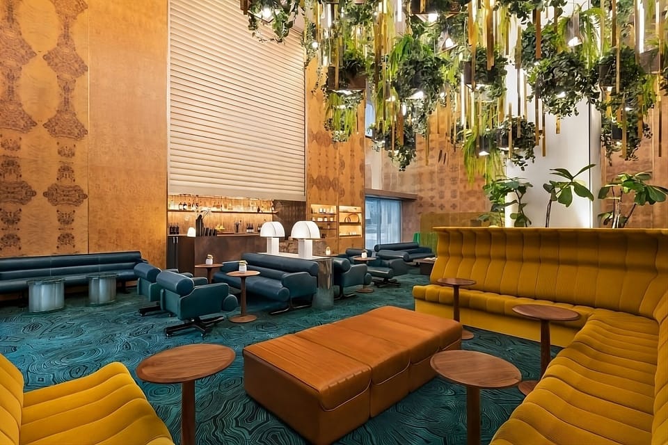 Sink into velvet seating beneath lush, glowing greenery.
