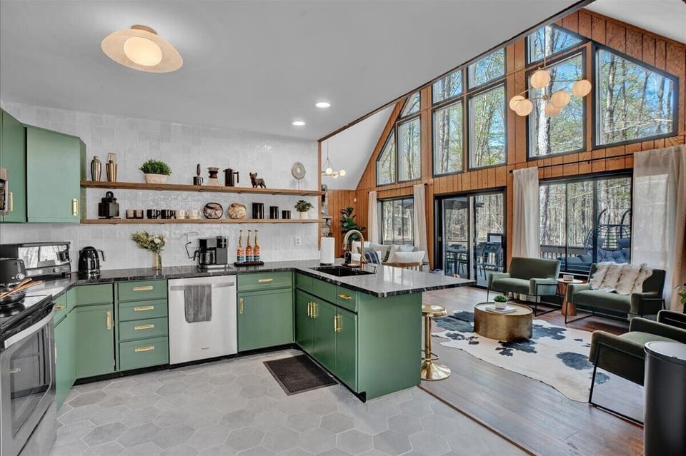 “Open-concept kitchen and living — cook, sip, and connect surrounded by forest views."