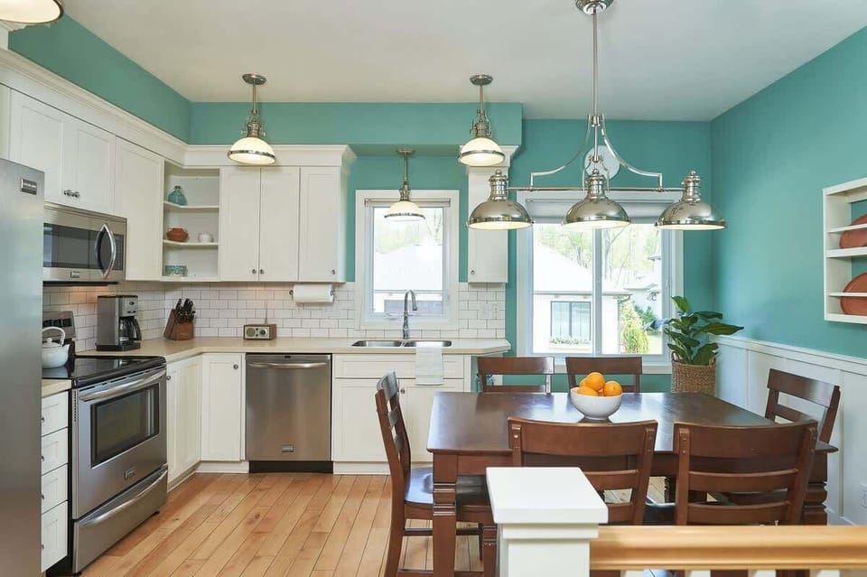 Fully equipped kitchen with appliances and dining table 