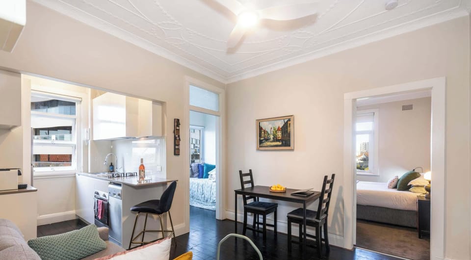 Open plan living and dining area with dark floorboards