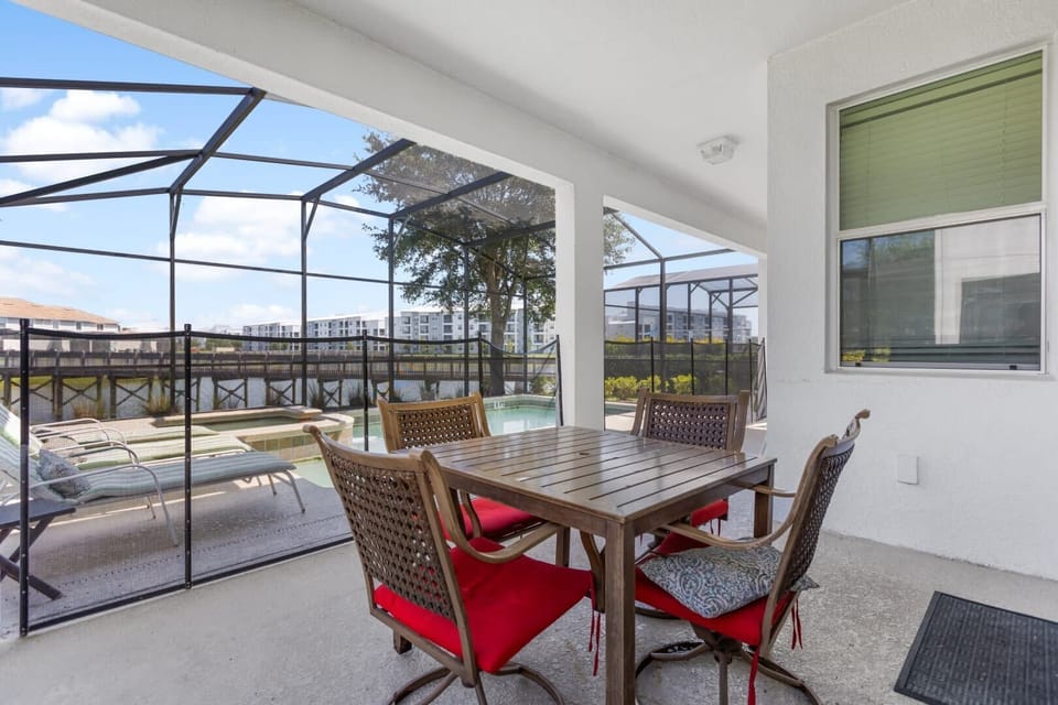 Relax on the private patio with a pool view, perfect for outdoor dining and enjoying serene pond views.