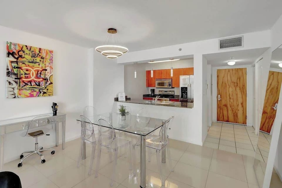 The open living room seamlessly connects to the balcony, kitchen, dining area, and dedicated workspace!