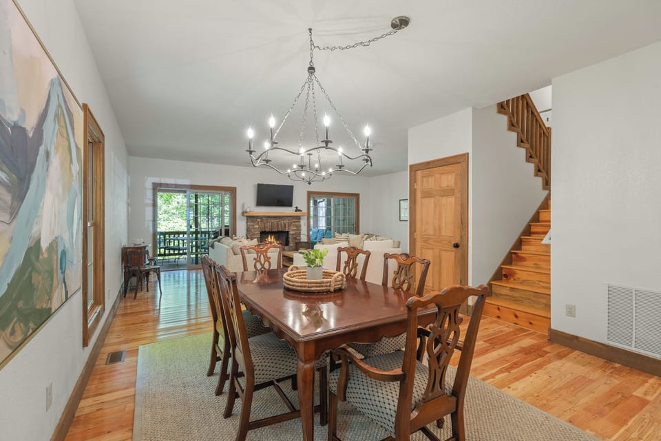 The dining room opens into the living room and stairs to the 2nd and 3rd floors