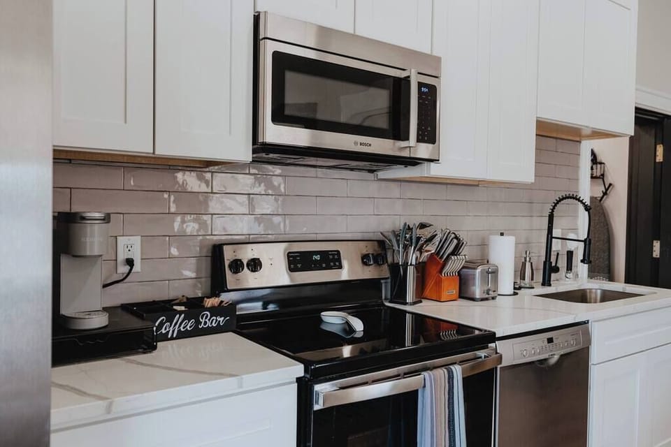 Kitchen — stone counters, coffee setup, and cookware provided