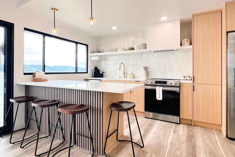Modern, thoughtfully designed kitchen with sleek finishes and stunning Hood Canal views.