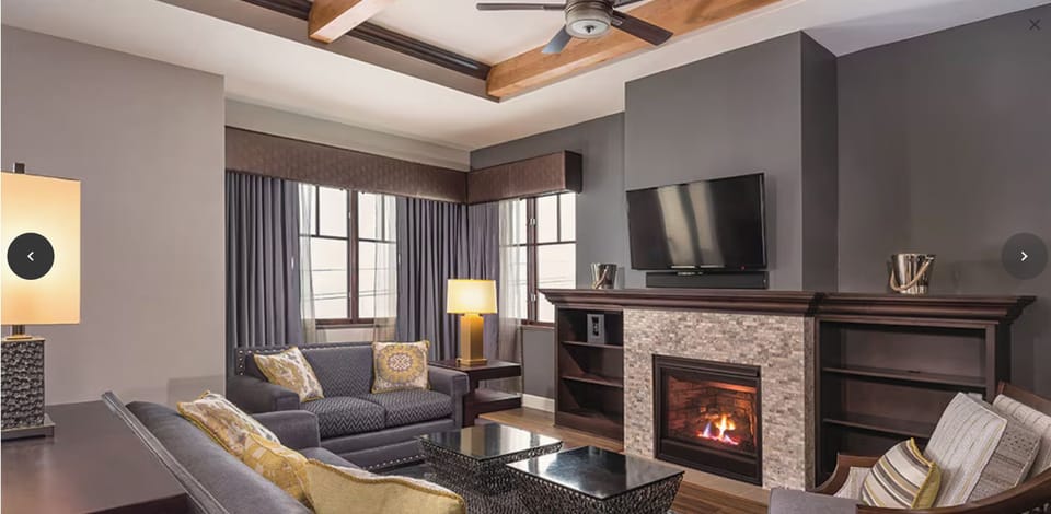 Living room with TV and fireplace