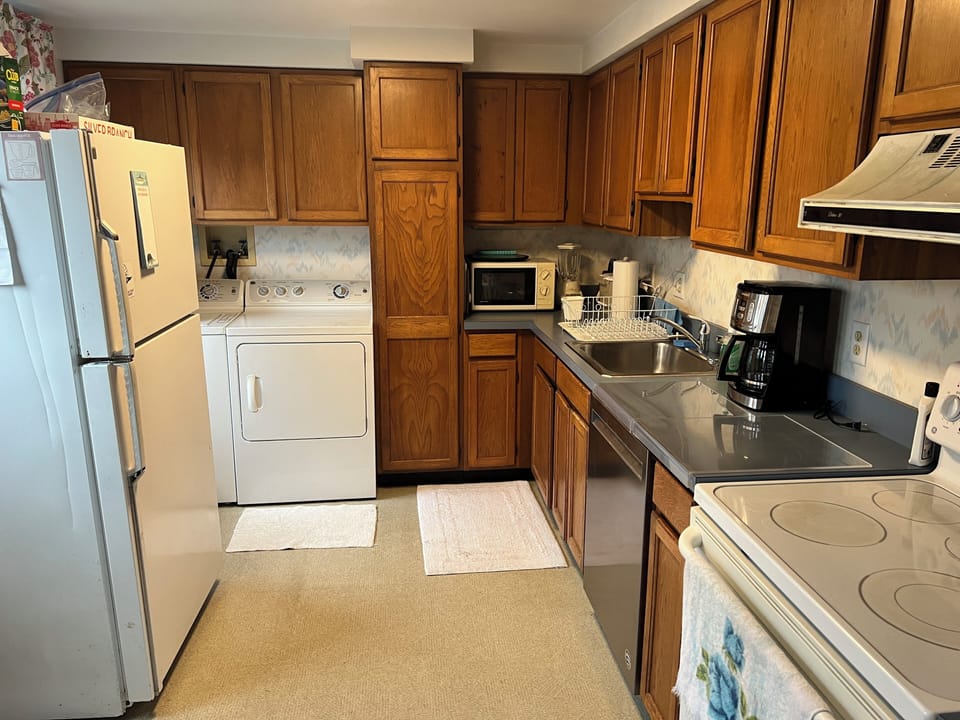 Kitchen includes new coffee maker, microwave, and toaster, plus blender and more