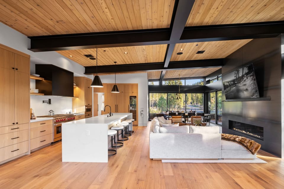 Main Living Space: Living room and kitchen, open layout, soaring windows, sliding glass doors to outdoor living space