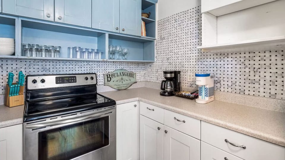Cook your favorite meals in this bright, fully equipped kitchen with modern appliances and ample prep space.