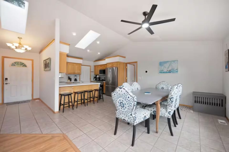 Dining table with seating for 6 and 4 barstools at kitchen counter.