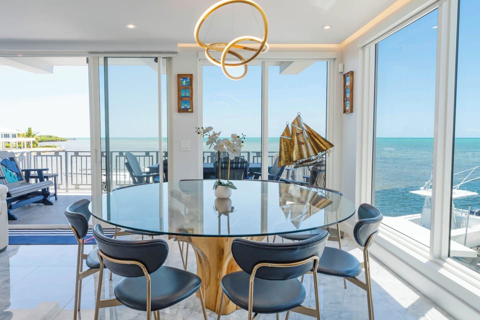 Bright dining with nautical touch, large windows, and ocean view.