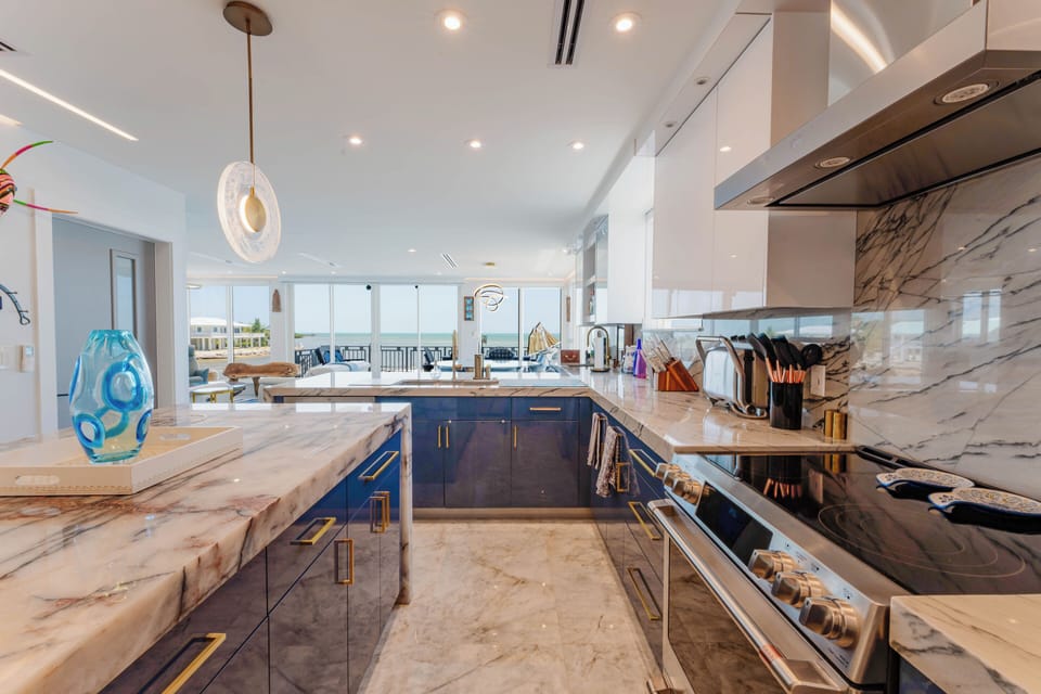 Open-concept kitchen with ocean views, marble island, and stylish decor
