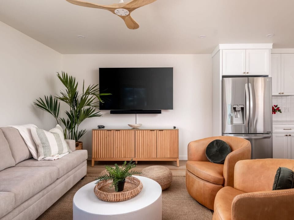 Ocean-view living room with a queen sofa sleeper, PS5, Xbox, and board games.