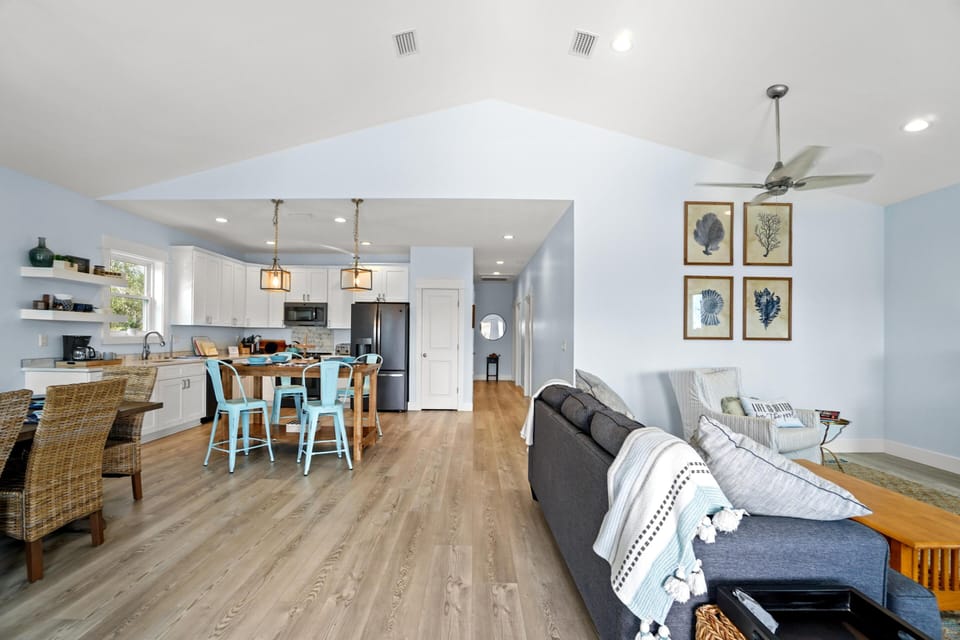 Step into your bright, open-concept retreat where coastal blues and modern comfort blend seamlessly for your perfect getaway.