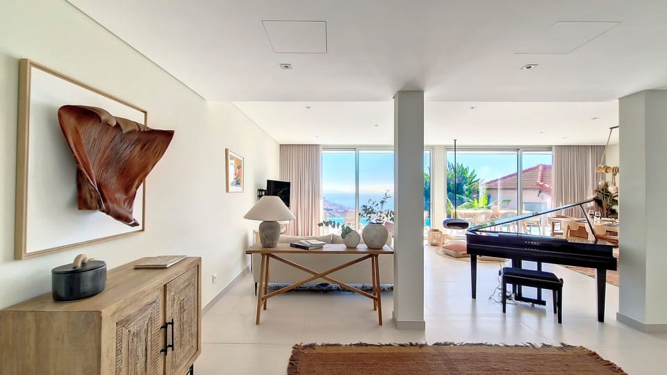 The living room at Villa Obra Prima is a harmonious blend of modern elegance and comfort. It's the perfect place to relax and enjoy quality time with family and friends. #piano #openspace #modern
