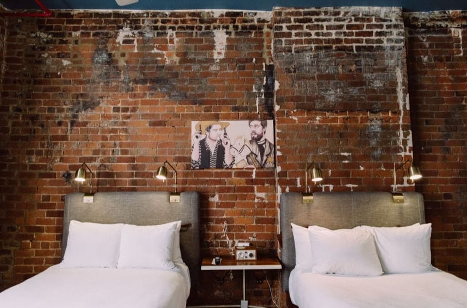 Rustic brick wall backdrop with elegant white armchairs for a relaxing read