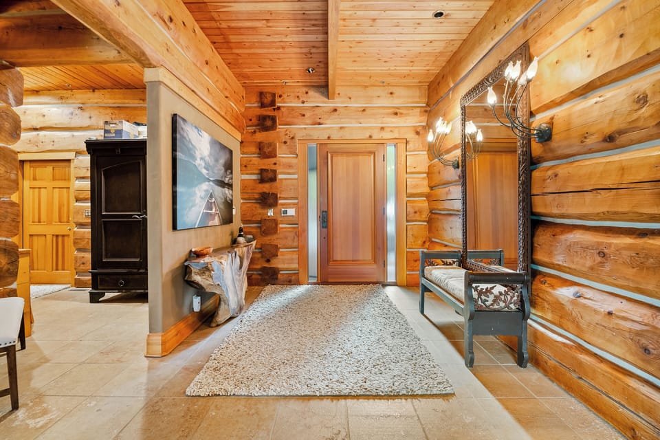 Entrance foyer to the home with a seating bench for removing shoes. 