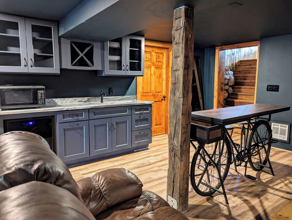 Movie room with wet bar, microwave, beverage fridge, bike bar, OLED TV