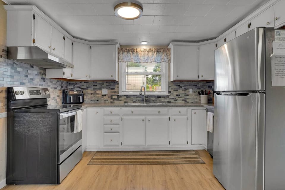A spacious kitchen with plenty of counter space and all the essentials for preparing meals, offering both style and functionality.