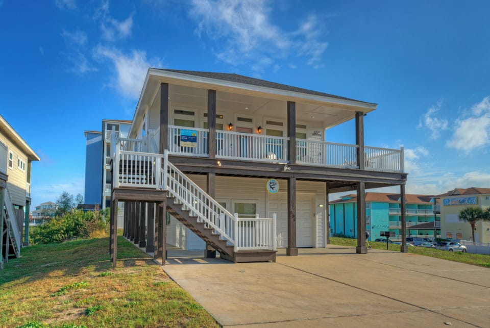 Classic coastal charm—this elevated beach home features breezy porches, covered parking, and an ideal layout just moments from the shore.