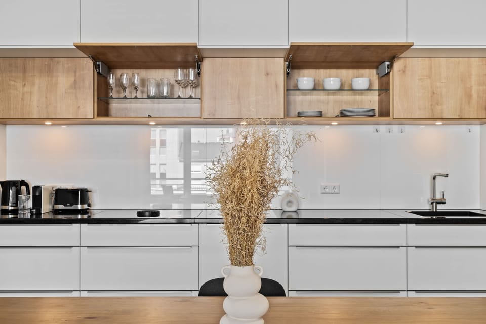 Fully equipped kitchen with sleek cabinetry and high-quality appliances, perfect for preparing your favorite meals.
