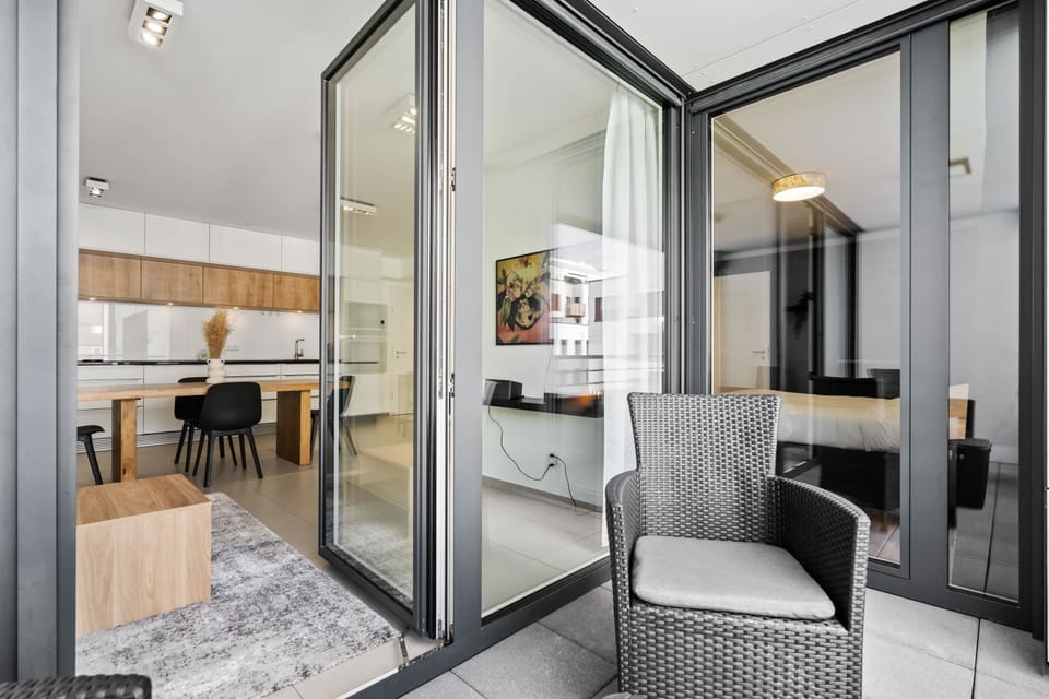 Spacious balcony offering a delightful extension of the living area, with comfortable seating and a view of the stylish interior.
