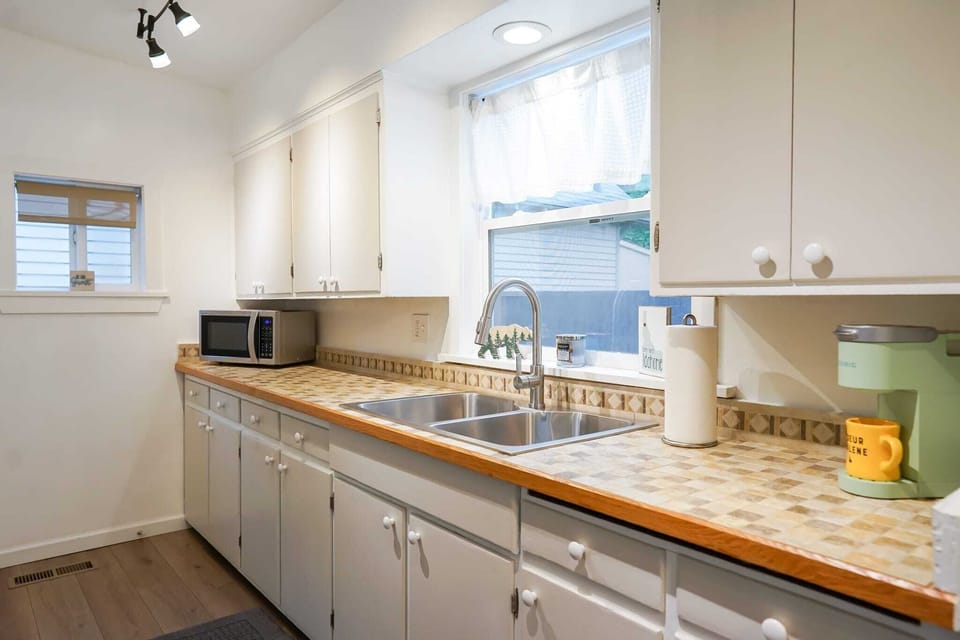 Our charming kitchen with retro tiles, basking in sunlight. The perfect bright and cheerful spot to prep any meal