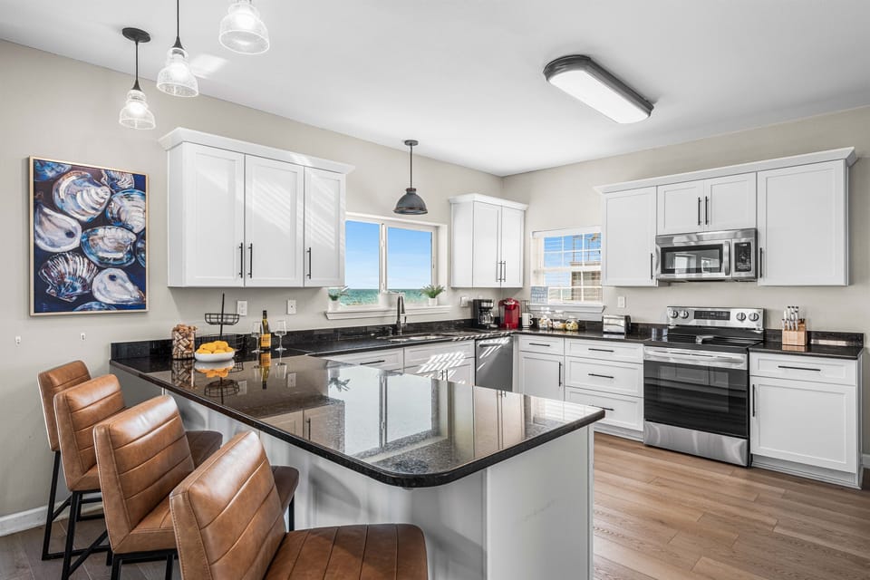 Cook with confidence in your fully equipped kitchen featuring granite countertops, modern appliances, and a spacious island perfect for meal prep.