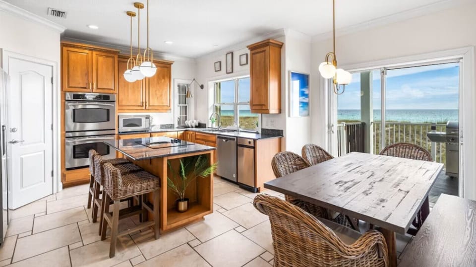 Your fully-equipped kitchen flows seamlessly into a dining space where ocean breezes and stunning sea views create the perfect backdrop for memorable meals.