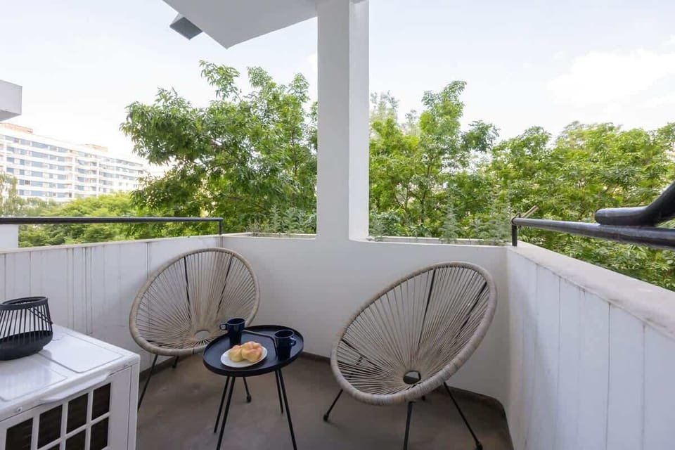 A cozy balcony with two chairs and a small table. Perfect for a morning coffee or evening chat.