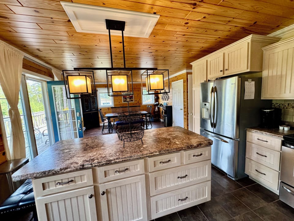 Six foot island with bar stools. Open concept kitchen/dining.