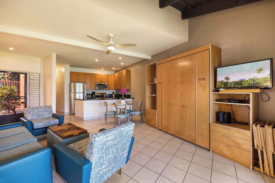 Spacious living area with dining table and chairs.