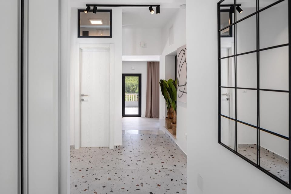 hallway taking you to a spacious and beautifully furnished living room