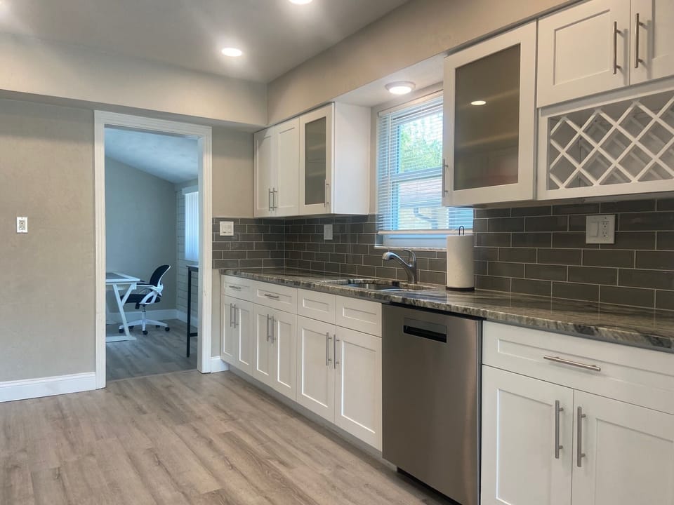 The kitchen is fully equipped with a dishwasher, oven, toaster and refrigerator.