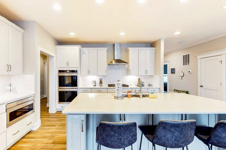 Cook and dine in a modern, fully-equipped kitchen with sleek finishes and a spacious island seating area.