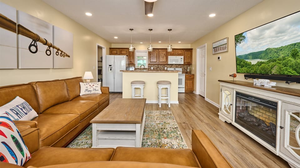 Enjoy watching television in the well lit Living Room upstairs. There is a leather couch and loveseat, a fireplace cabinet with electric space heater built in. and a coffee table that will raise up for an dining or computer surface.