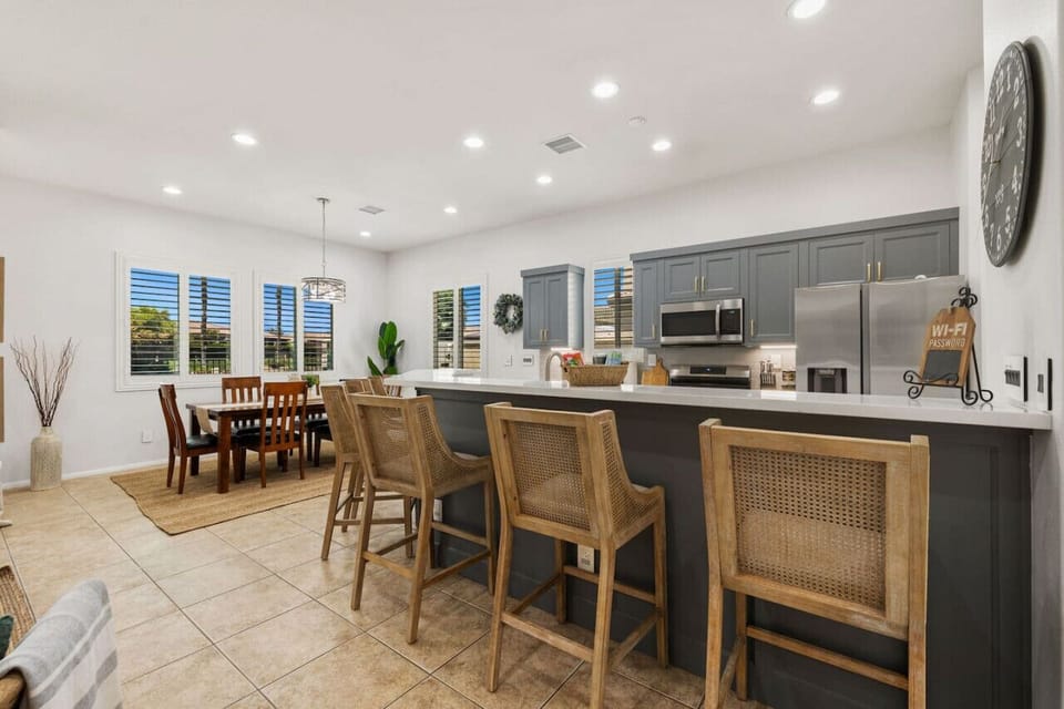 Open dining area w/ long table & bar seating, made for gathering & meals together.