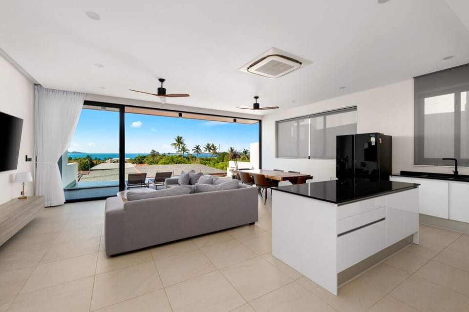 Spacious open-plan living area with panoramic sea views, European-style kitchen and modern furnishings - perfect for families