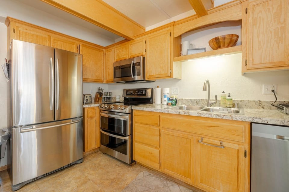 Fully equipped cabin kitchen with ample cabinetry, stove, fridge, microwave, and coffee maker—perfect for cooking meals, morning coffee, and feeling right at home on your stay.