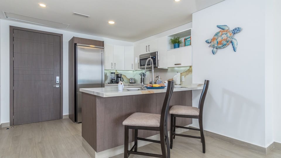 Two seats at the kitchen counter provide the setting.