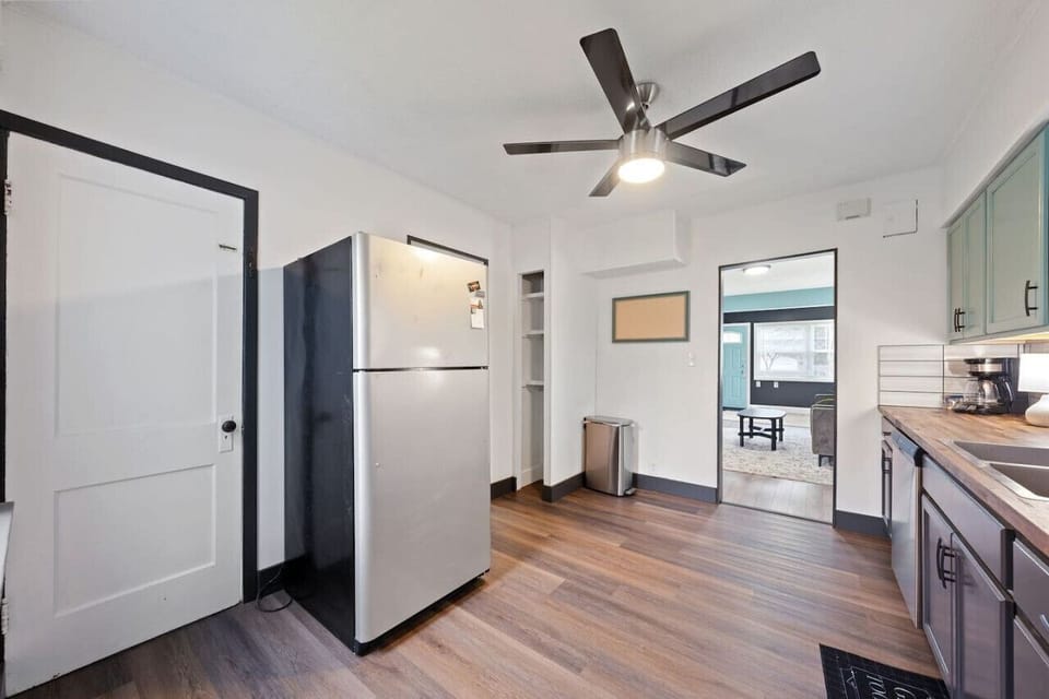 Modern kitchen with full-size fridge, dishwasher, and cookware provided — ideal for longer stays.