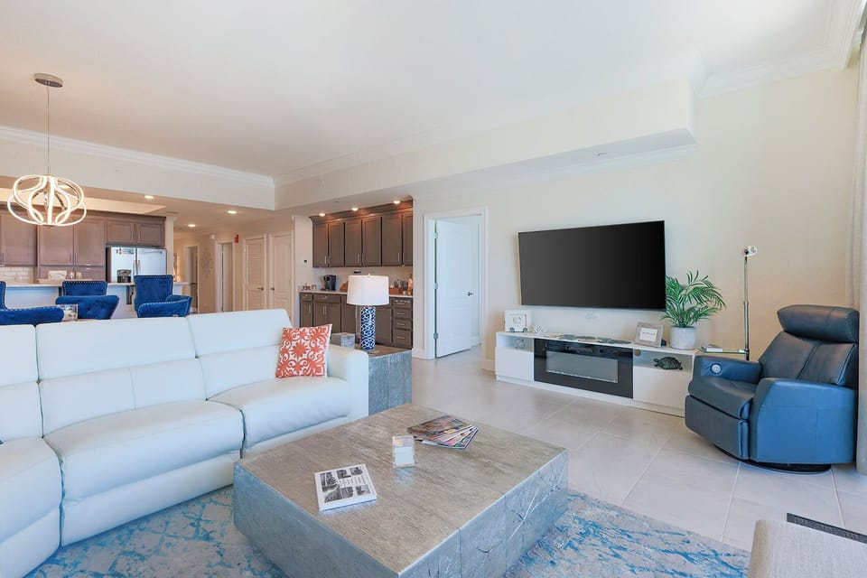 Unwind on the white sofa, stream favorites on the TV, and relax by a cozy fireplace in this inviting space