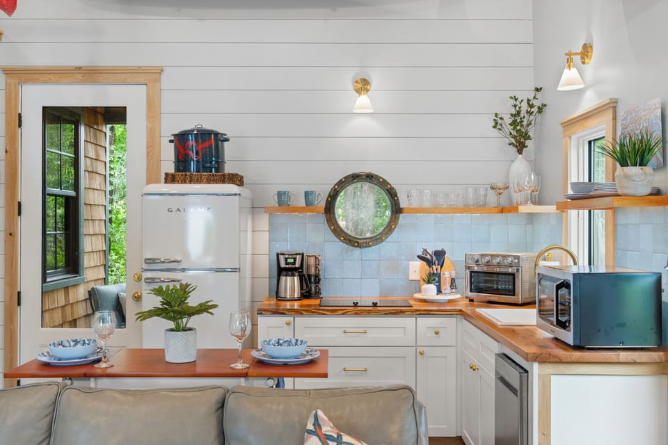 Enjoy a beautifully crafted kitchen with warm wood accents and nautical touches.