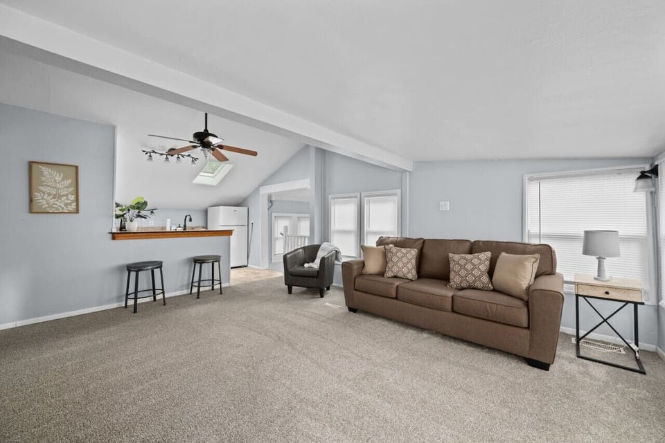 Living room with new comfy Ashley lounge sofa and modern carpet