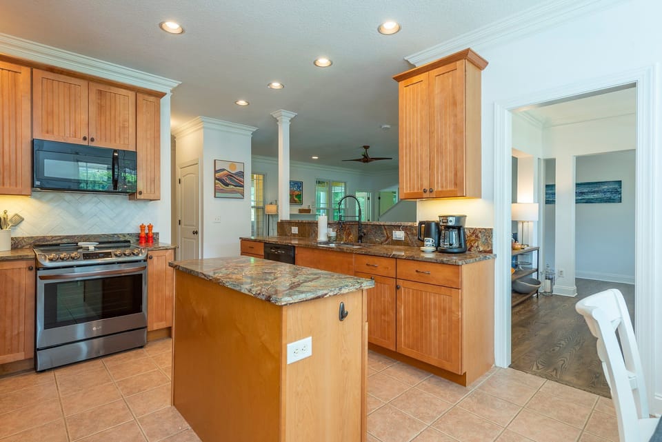 Kitchen with dishwasher, drip-style coffee pot, electric kettle, and breakfast nook