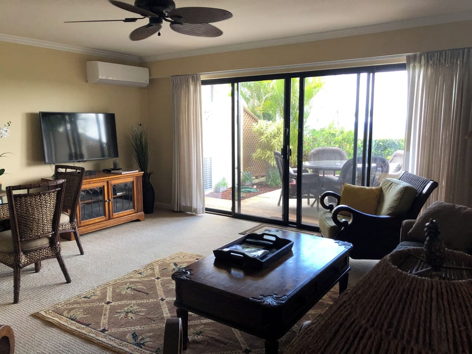 Living room, mini split a/c. dining table and open concept living area.