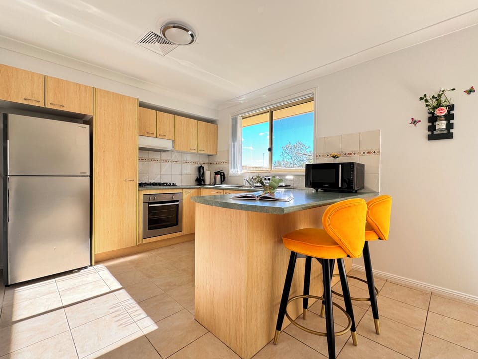 The fantastic kitchen is fully equipped with essential appliances.